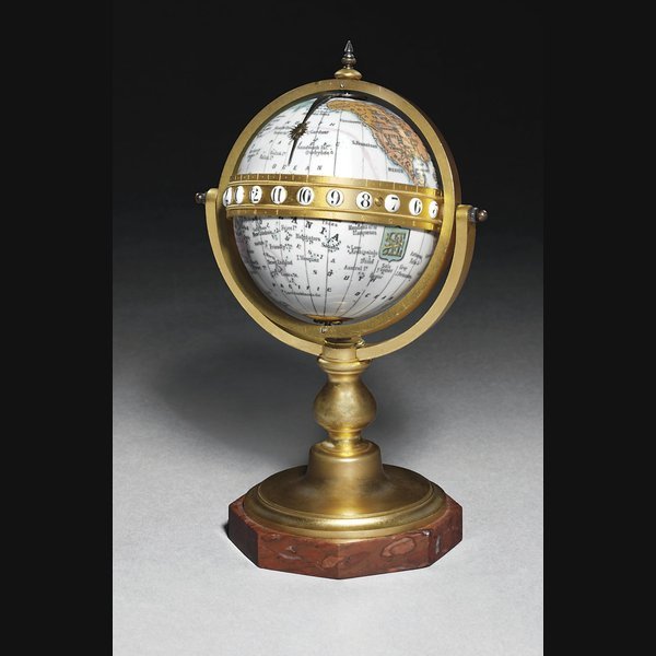 A French Enamel A French enamel, gilt-brass and rouge marble eight day globe timepiece CIRCA 1890